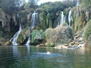 Kravice waterfalls cascading down to a serene pool that you can swim in