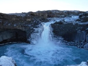 Aldeyjarfoss waterfall is a winding and hidden cascade surrounded by basalt columns and a wide plunge pool