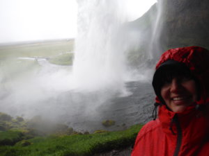 A selfie taken from behind the waterfall Seljalandsfoss in the south of Iceland