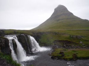 The popular mountain Kirkjufell and Kirkjufellsfoss in the foreground on a misty morning