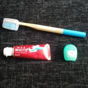 The dental hygiene items I travel with - bamboo toothbrush, toothpaste and dental floss