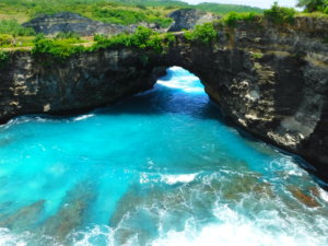 An photo of Broken Beach on Nusa Penida with turquoise waters breaking over the shore. This is an amazing place to visit on your first visit to Bali