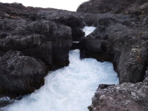 The powerful Barnafoss waterfall with a text explanation of how the falls were named